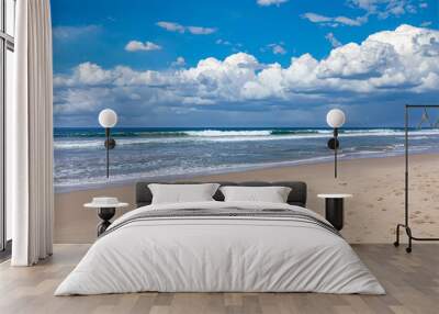 Sandy beach empty. Blue sky with clouds, blue sea Wall mural