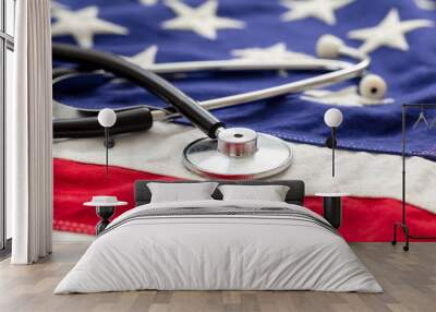 US of America health. Medical stethoscope on a USA flag, closeup view. Wall mural