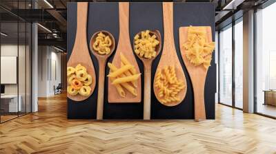 Various shapes of pasta on a black background Wall mural