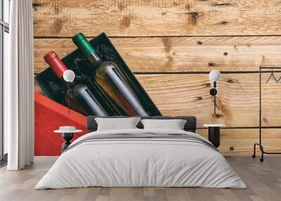 Wine bottles on wooden background, top view, copy space Wall mural