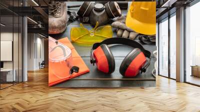 Work safety protection equipment background. Industrial protective gear on wooden table Wall mural