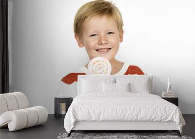 A boys is holding a candy Wall mural