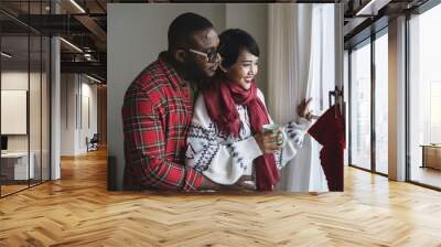 A cheerful couple enjoying Christmas holiday Wall mural