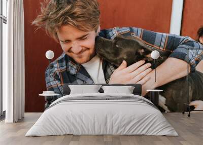 A man with his pit bull terrier dog Wall mural