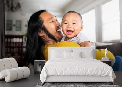 Asian American father hugging his little son Wall mural