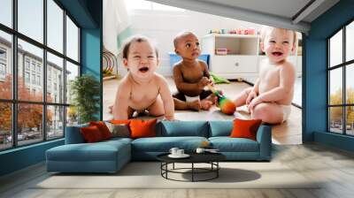 Babies playing together in a play room Wall mural