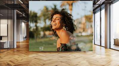 Beautiful woman posing in the park Wall mural