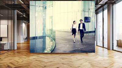 Business people discussing while walking together Wall mural