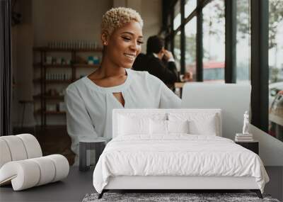 Businesswoman using a laptop Wall mural