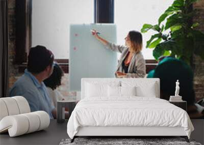 Businesswoman writing on a board in the meeting room Wall mural