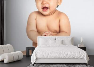 Cheerful baby in a studio Wall mural