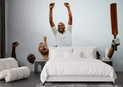 Cheerful cricketers celebrating their victory Wall mural