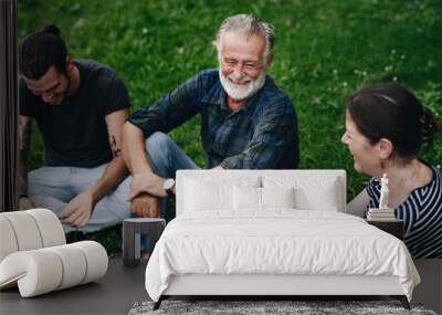 Cheerful friends having a conversation in the park Wall mural