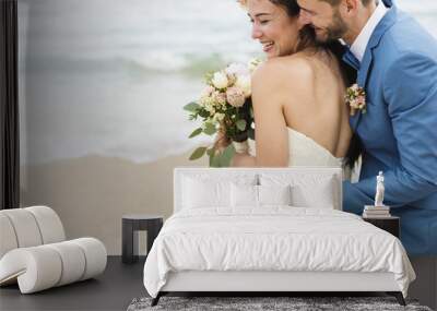 Cheerful newlyweds at beach wedding ceremnoy Wall mural