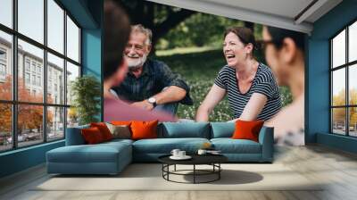 Cheerful woman in the park with her friends Wall mural