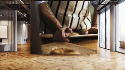 Chef baking pastry homemade and using tablet Wall mural