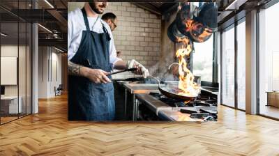 Chef cooking food in the restaurant kitchen Wall mural