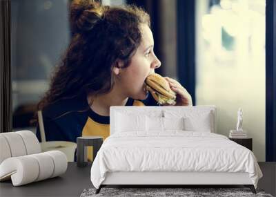 Close up of teenage girl eating hamburger obesity concept Wall mural