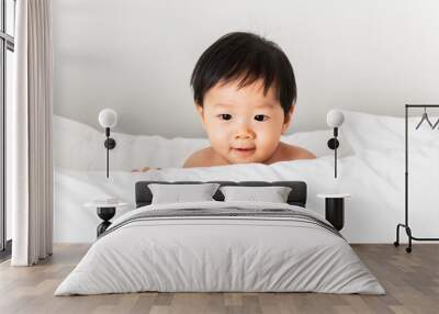 Closeup of a baby playing with a pillow Wall mural