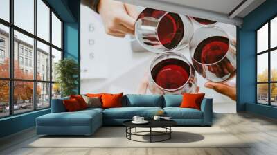 Colleagues toasting wine glasses at work Wall mural