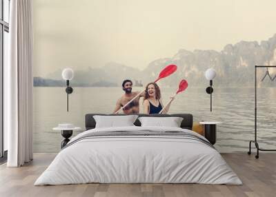 Couple paddling in a canoe Wall mural