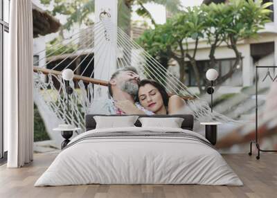 Couple resting together in a hammock Wall mural