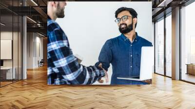 Diverse colleague men shaking hands together Wall mural