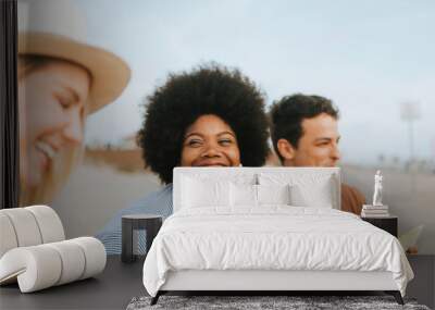 Diverse friends enjoying their beach picnic Wall mural