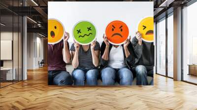 Diverse people holding emoticon Wall mural