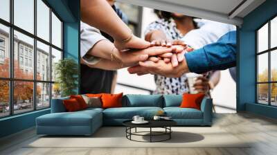 Diverse startup business team stacking hands Wall mural