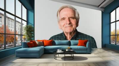 Elderly Caucasian man with white hair smiling on gray background Wall mural