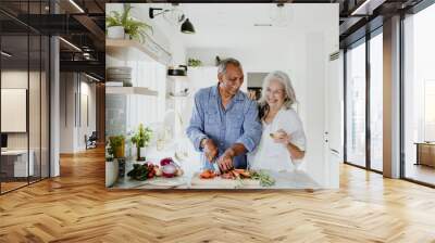 Elderly couple cooking in a kitchen Wall mural