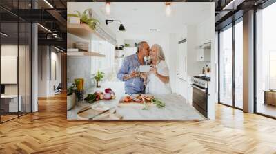 Elderly couple taking a selfie while cooking in a kitchen Wall mural