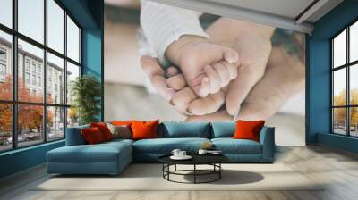 Father and mother are taking care of their child. Wall mural