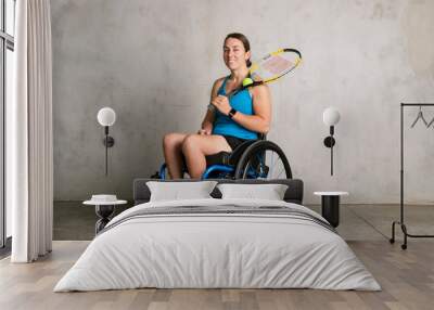 Female athlete in a wheelchair holding a tennis racket Wall mural