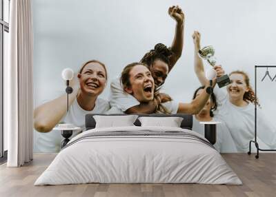 Female football players celebrating their victory Wall mural