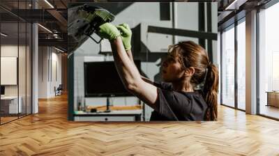 Female mechanic fixing a car Wall mural