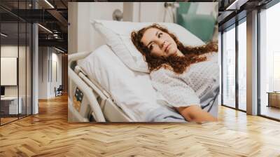 Female patient resting in a hospital bed Wall mural