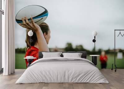 Female rugby player holding a ball Wall mural