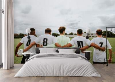 Football players standing together side by side Wall mural