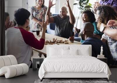 Friends playing game together at home Wall mural