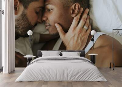 Gay couple cuddling in bed Wall mural