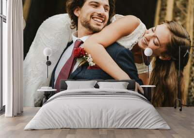 Groom lifting up his beautiful bride Wall mural