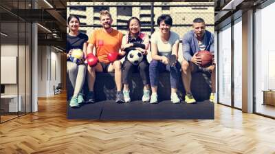 Group of diverse athletes sitting together Wall mural