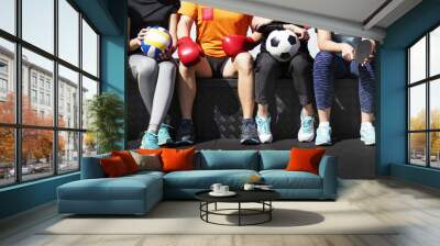 Group of diverse athletes sitting together Wall mural