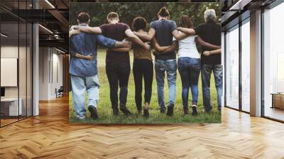 Group of friends huddle in rear view together Wall mural