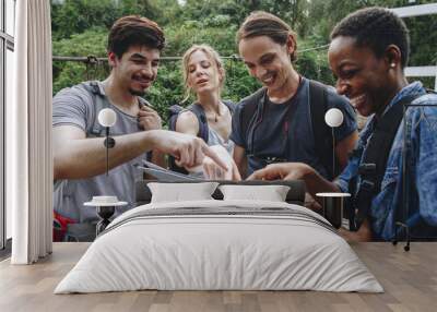 group of friends looking at a map together travel and teamwork concept Wall mural