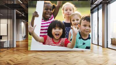 Group of kindergarten kids friends playing playground fun and smiling Wall mural