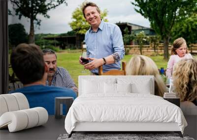 Group of people having dinner in the backyard Wall mural