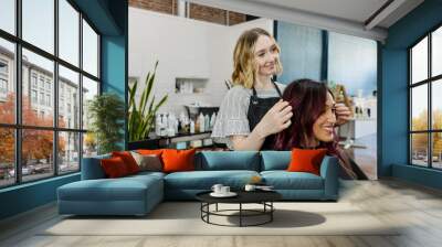 Hairstylist giving a haircut to a customer at a beauty salon Wall mural